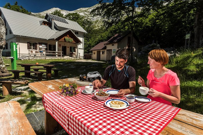 The mountaineers enjoy good home-made food in front of the hut